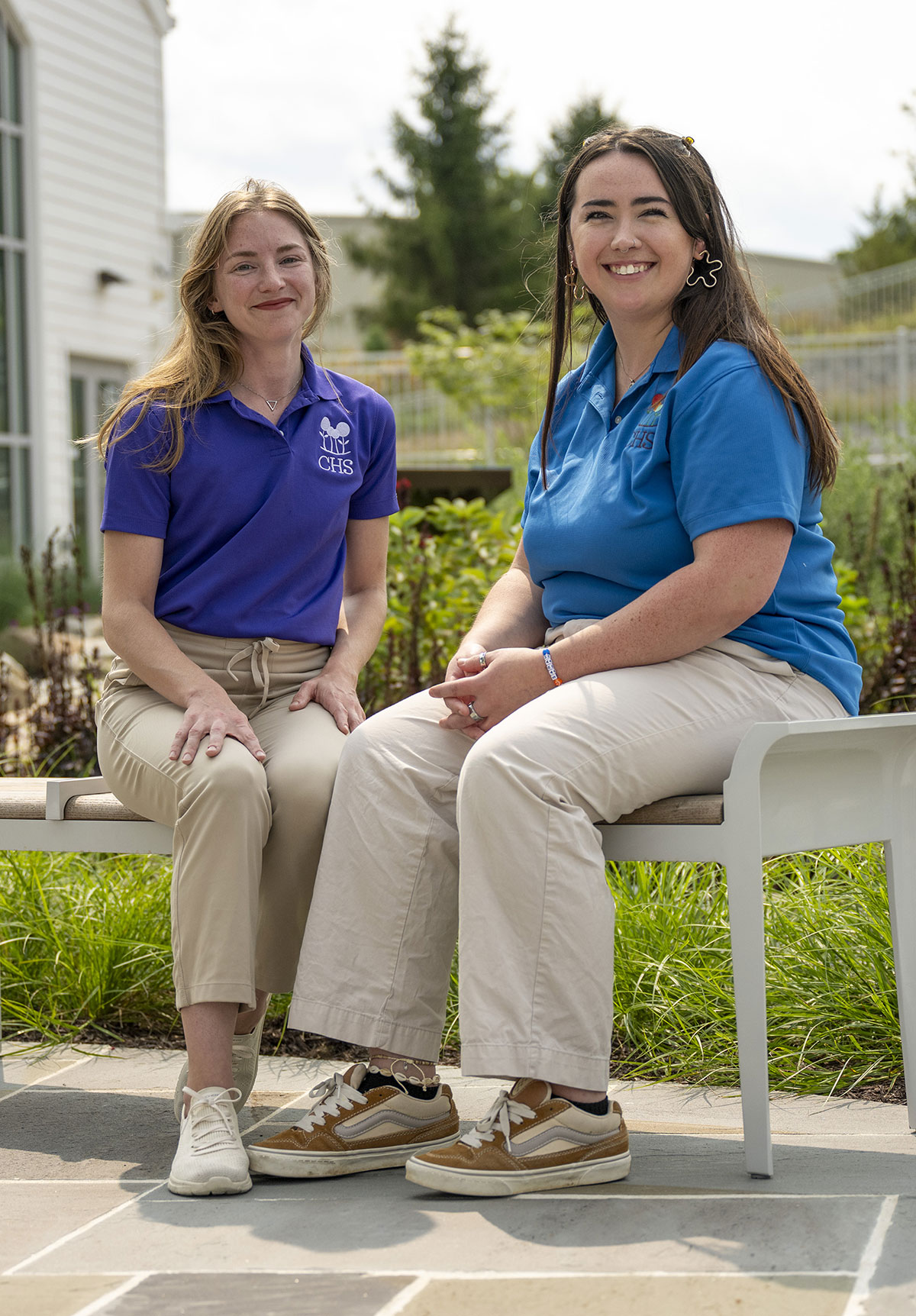 Teacher working with a student to color with crayons